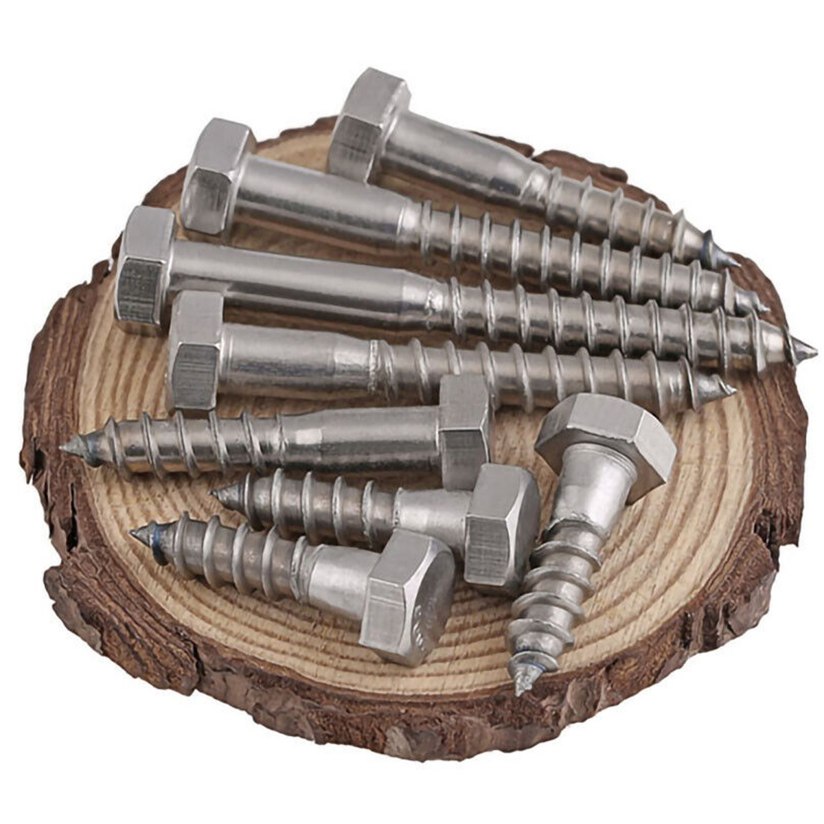 Hex head coach screws in several lengths, with plain shanks and coarse wood-screw threads, laid on a slice of timber log