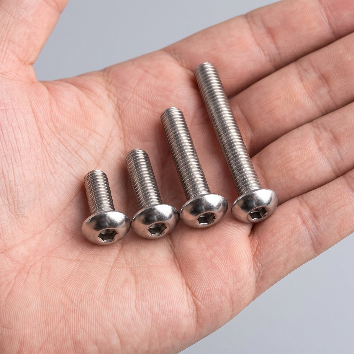 DIYUK A2 Stainless Steel Hex Socket Button Head Bolts (ISO 7380), shown in hand for scale