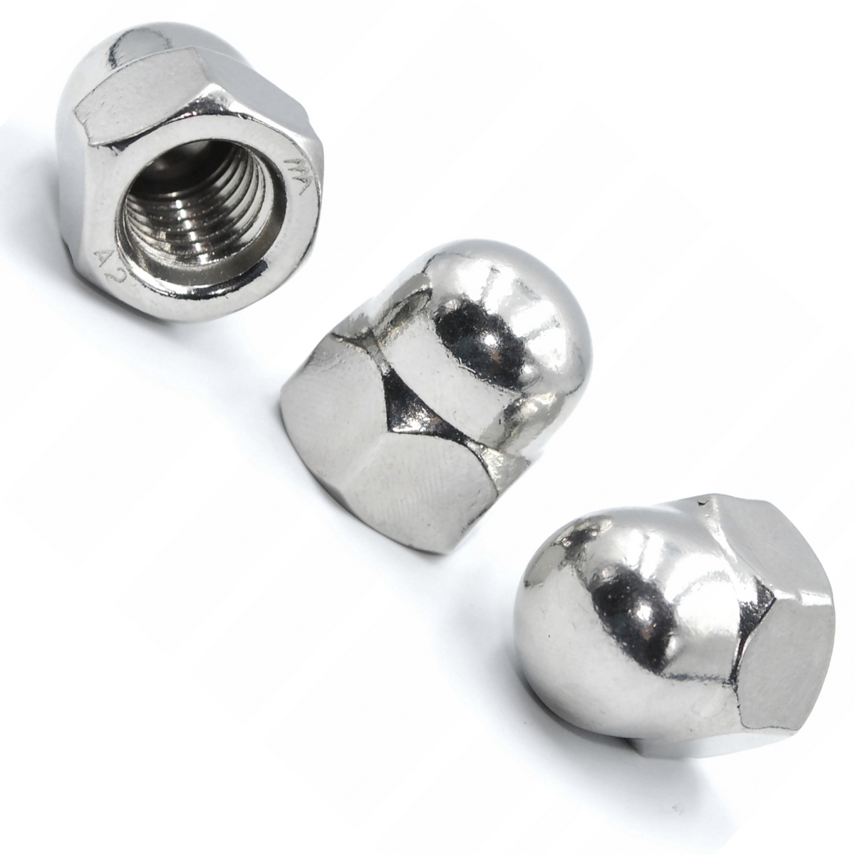 Three A2 stainless steel hex acorn cap nuts on a white background