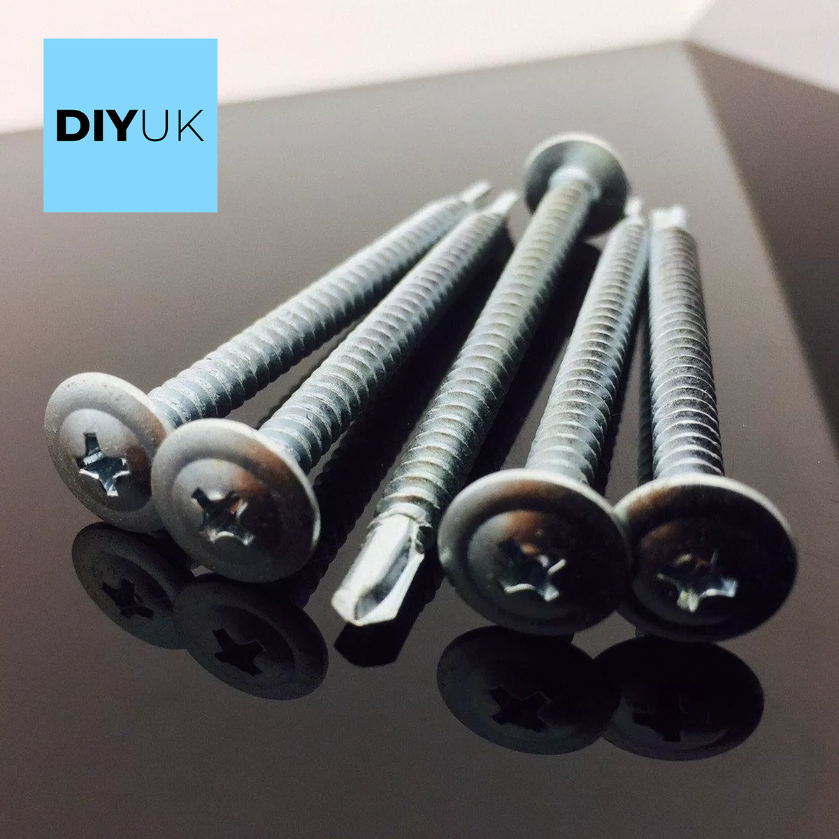 Close-up of a bright zinc-plated self-drilling baypole screw with a low-profile wafer head, designed for flush UPVC window installations.