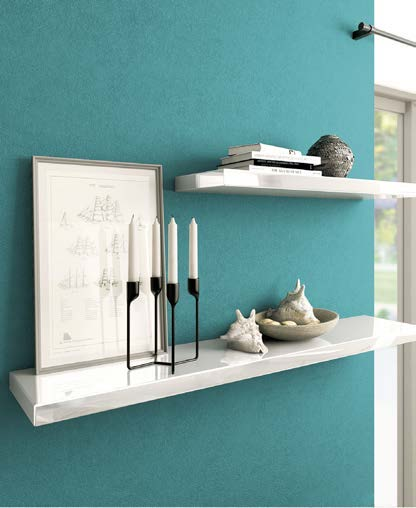 White gloss floating shelves mounted on a teal wall