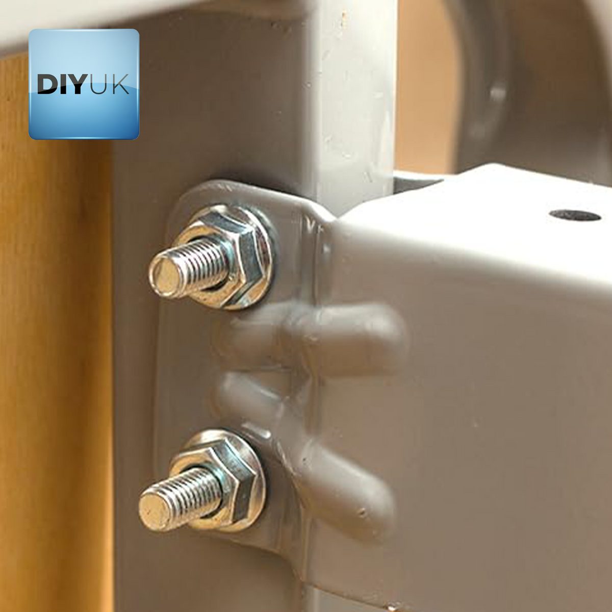 Bright zinc-plated hex nuts tightened on bolts through a metal bracket