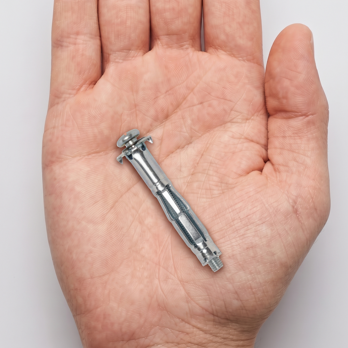 Heavy-Duty Metal Cavity Wall Fixings & Molly Bolts for Plasterboard, shown in hand for scale