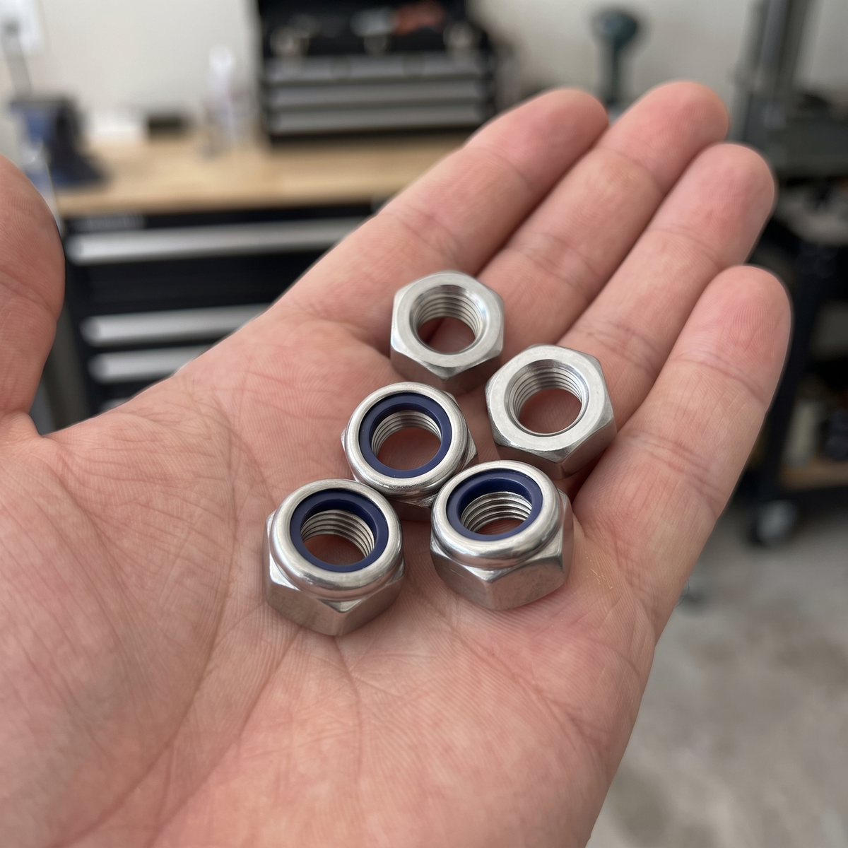 Nyloc Lock Nuts DIN 985 Zinc Plated Steel (M3-M24), shown in hand for scale