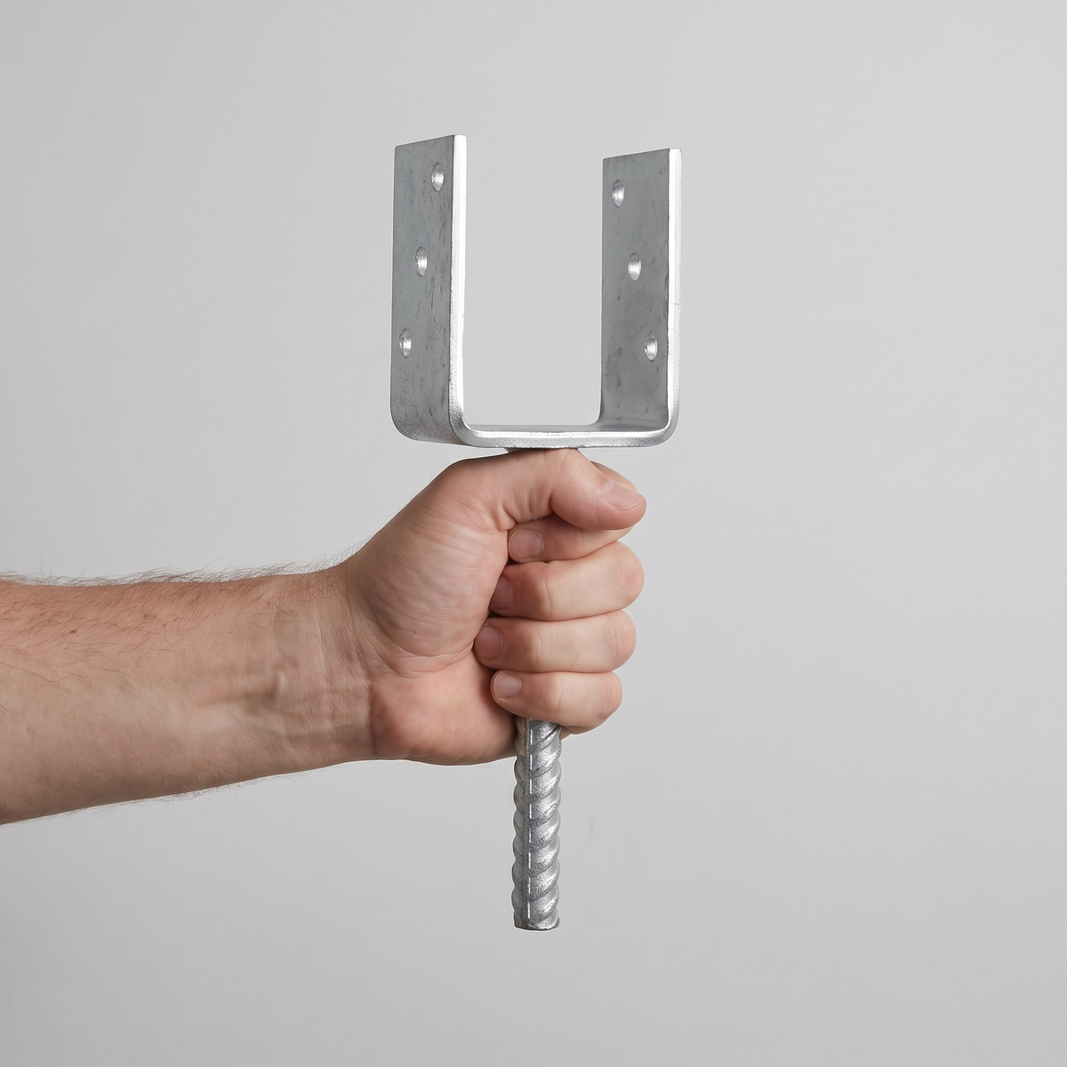 Heavy Duty U-Shape Post Support Base Bracket – Concrete-In Anchor, shown in hand for scale, silver