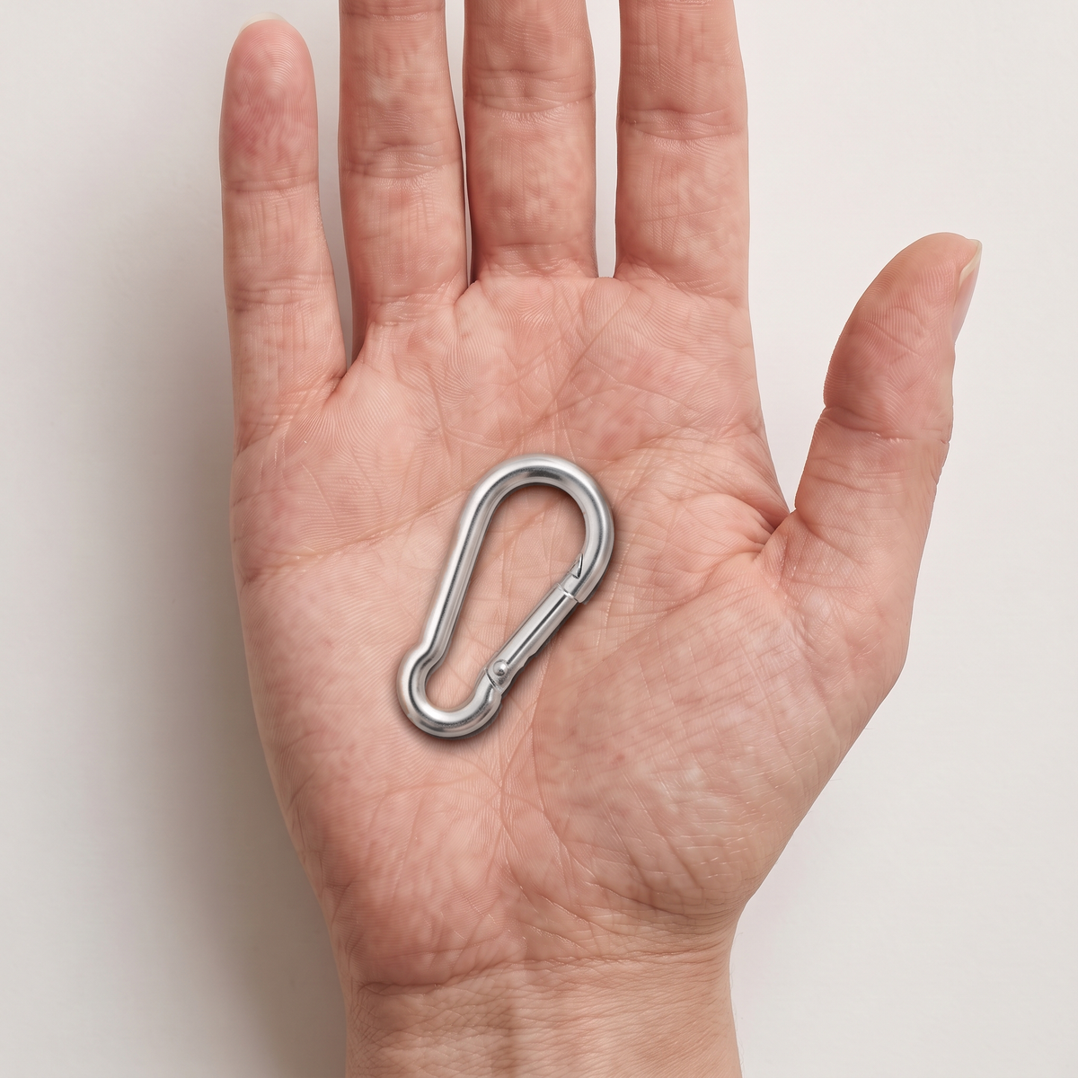 Heavy Duty Galvanised Zinc-Plated Steel Carabiner Snap Hook Clip (DIN 5299C), shown in hand for scale