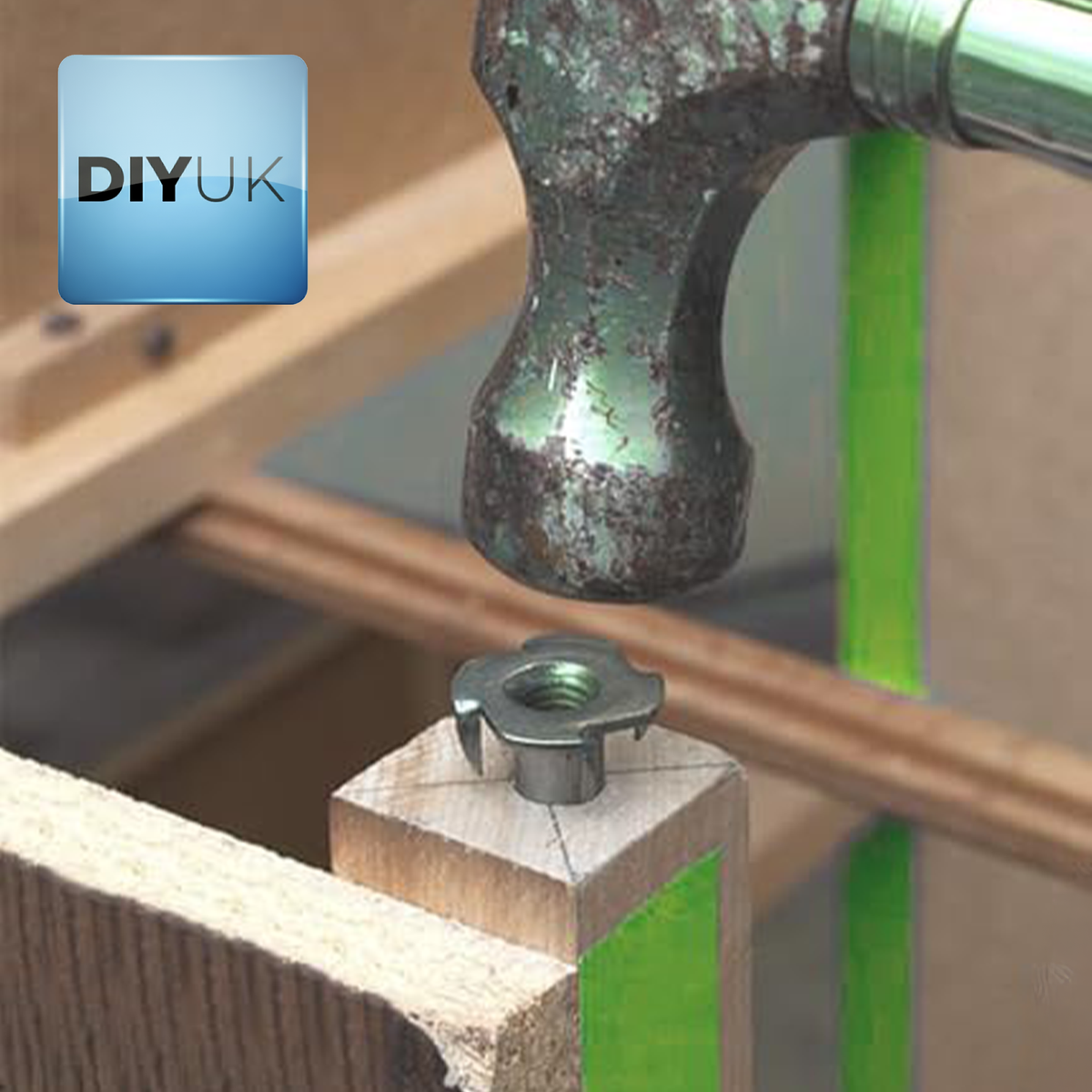 Zinc plated T-nut being tapped into a timber post with a hammer