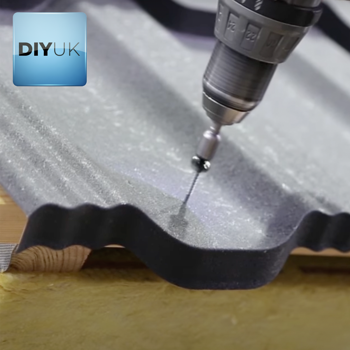Hex head Tek roofing screw being driven into a profiled metal roof sheet with a power driver