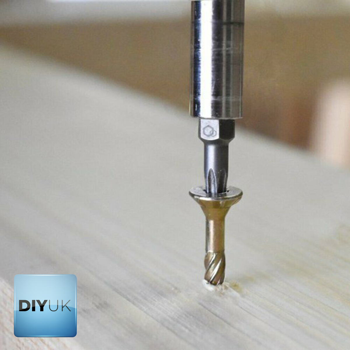 Torx bit driving a yellow zinc-plated countersunk wood screw into timber