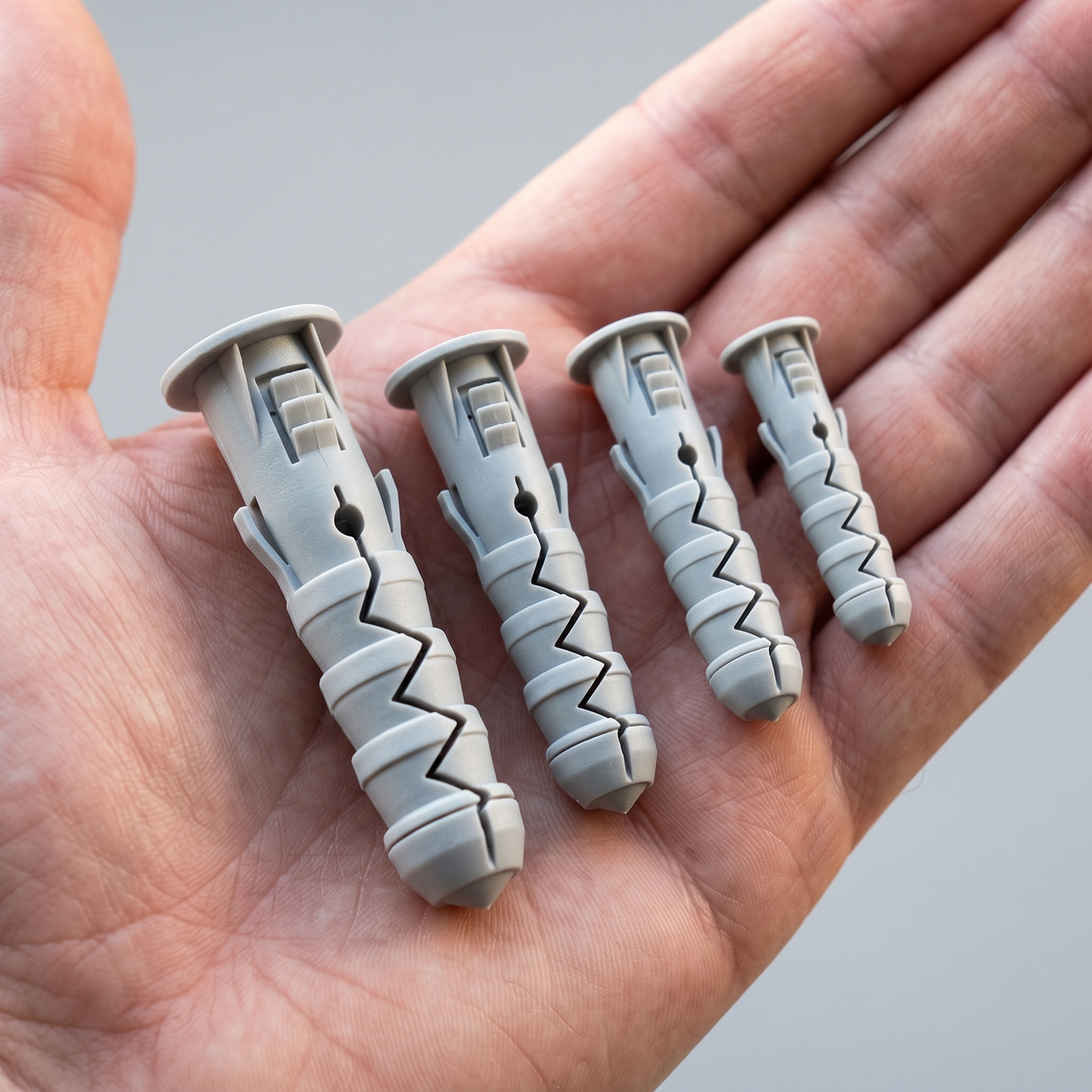 DIYUK Masonry Wall Plugs, Polypropylene Expansion Fixings, shown in hand for scale