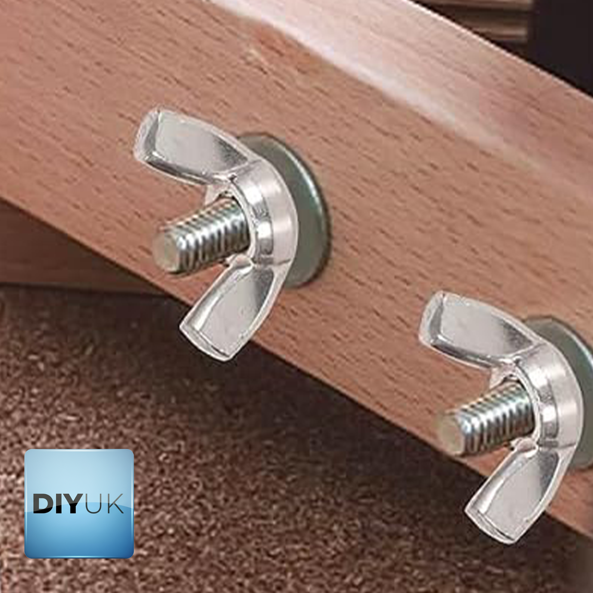 Two wing nuts with washers on threaded bolts through a wooden board