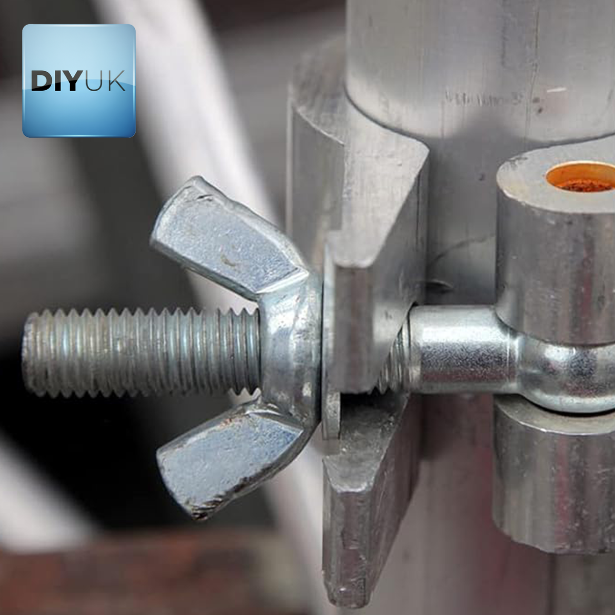 Wing nut on a threaded bolt fixing a metal clamp