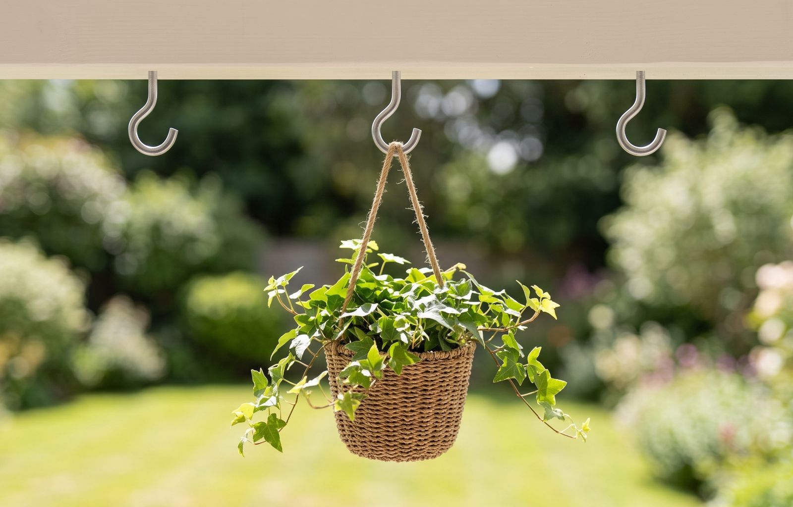 Hanging basket on a screw-in cup hook in a garden